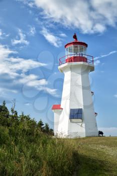 The red and white Cap Gaspe lighthouse in Gaspesie, Quebec, Canada during summer season