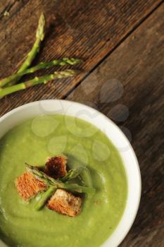 Asparagus soup on a wooden background