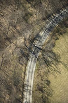 Royalty Free Photo of an Aerial View of a Rural Country Dirt Road With Bare Trees