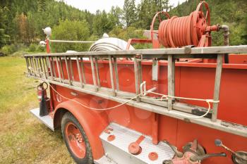 Close-up of old fire truck and ladder.