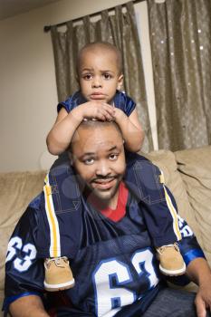 Royalty Free Photo of a Boy Sitting on His Father's Shoulders