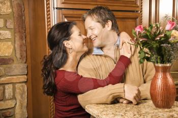 Royalty Free Photo of a Couple Hugging in a Kitchen