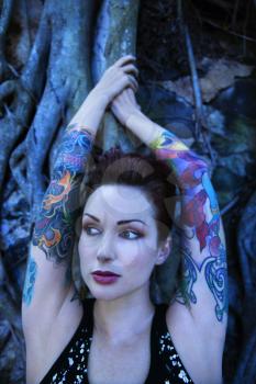 Royalty Free Photo of a Tattooed Woman With a Banyan Tree in Maui, Hawaii, USA