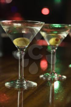 Royalty Free Photo of Two Martinis With Olives on a Bar 