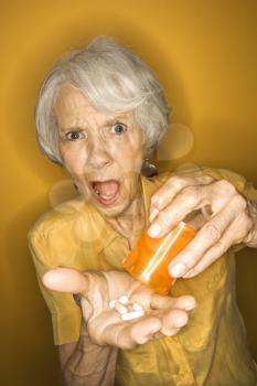 Royalty Free Photo of an Older Woman Taking Her Medication