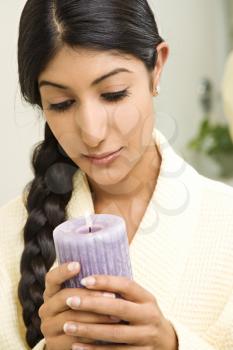 Royalty Free Photo of a Young Woman Holding Up a Lit Candle