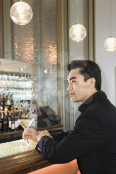Royalty Free Photo of a Man Sitting at a Bar
