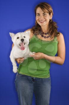 Royalty Free Photo of a Woman Holding a White Terrier Dog