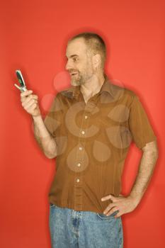 Royalty Free Photo of a Man Smiling at a Cellphone