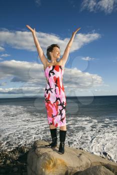 Royalty Free Photo of a Woman Standing With Arms Outstretched