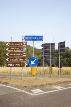 Road signs pointing different directions, Tuscany.