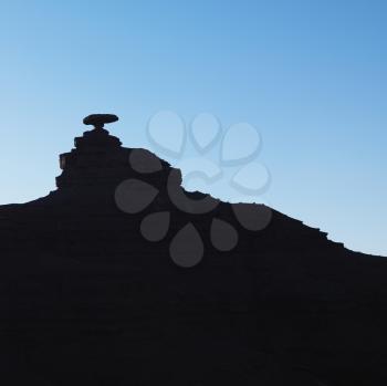 Royalty Free Photo of a Silhouette of Mexican Hat Rock Formation in Utah