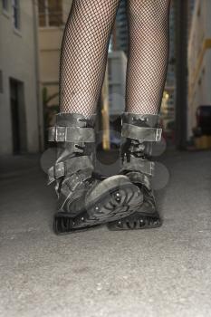 Royalty Free Photo of Legs and Feet Wearing Boots in an Urban Setting