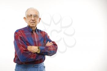 Royalty Free Photo of an Elderly Man Wearing a Plaid Shirt With Arms Crossed