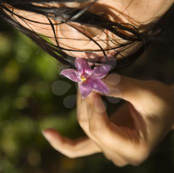 Royalty Free Photo of a Female Holding a Flower to Her Lips