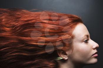 Royalty Free Photo of a Pretty Redhead Woman With Hair Streaming Out Behind Her