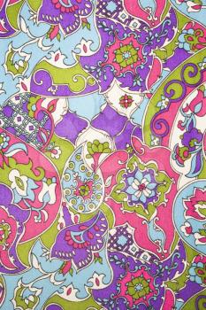 Royalty Free Photo of a Close-Up of a Colorful Vintage Fabric With Flowers and Shapes Printed on Polyester