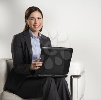 Royalty Free Photo of a Businesswoman Sitting Working on a Laptop