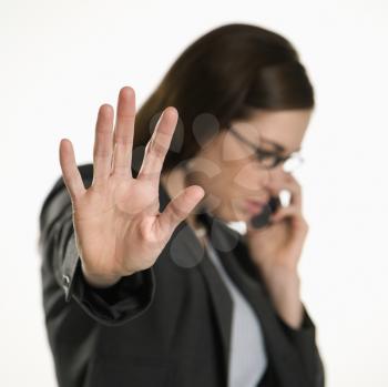 Royalty Free Photo of a Businesswoman Talking on a Cellphone Holding Her Hand Out