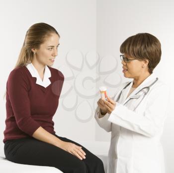 Royalty Free Photo of a Female Doctor Explaining Medication to a Female Patient