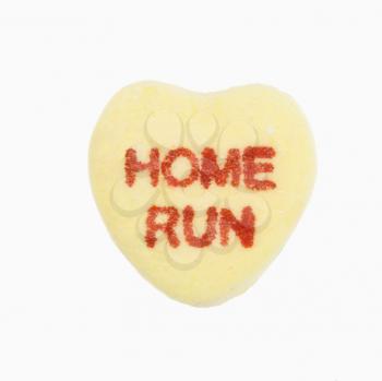 Royalty Free Photo of a Yellow Candy Heart That Reads Home Run