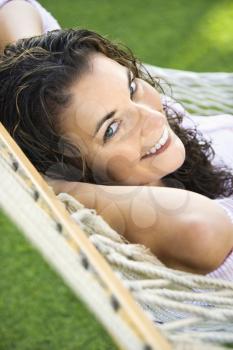 Royalty Free Photo of a Woman Lying in a Hammock and Smiling