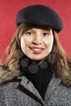 Royalty Free Photo of Young Woman Wearing a Flat Hat Smiling