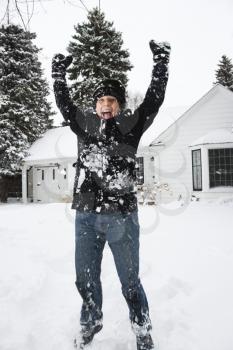 Royalty Free Photo of a Woman Jumping in the Air in the Snow