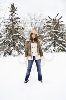 Royalty Free Photo of a Woman Standing in the Snow Wearing a Straw Cowboy Hat