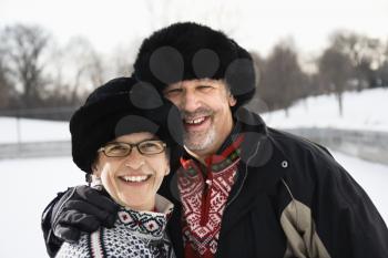 Royalty Free Photo of a Middle-Aged Man and Woman Wearing Black Winter Hats Smiling