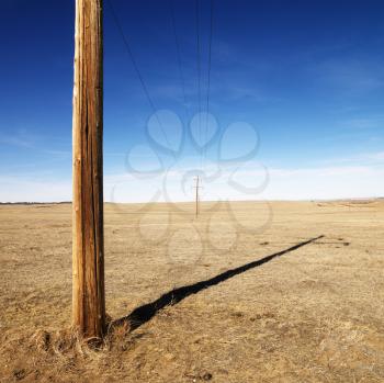 Royalty Free Photo of a Power Line Against a Blue Sky