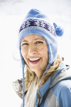 Royalty Free Photo of a Smiling Woman Wearing Blue Winter Clothing