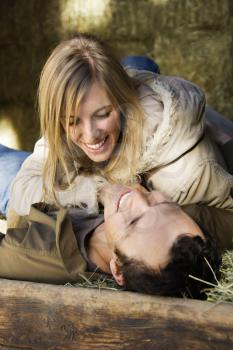 Royalty Free Photo of a Couple Laying in Hay 