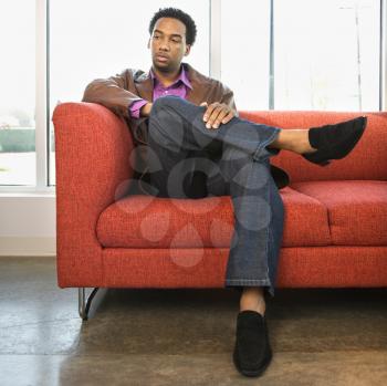 Royalty Free Photo of a Man Sitting on a Couch