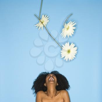 Royalty Free Photo of a Woman Tossing Fake Flowers in the Air