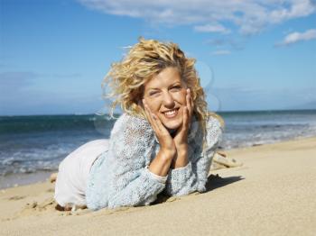 Royalty Free Photo of a Blonde Woman Laying on a Beach in Hawaii