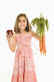 Royalty Free Photo of a Smiling Girl Holding a Bunch of Carrots and an Apple 