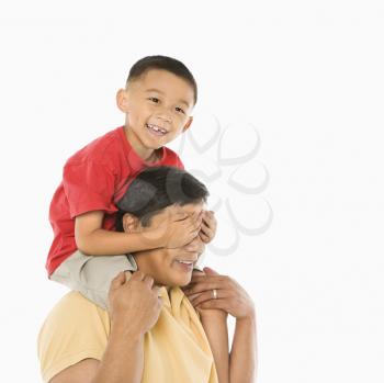 Royalty Free Photo of a Boy Sitting on His Father's Shoulders