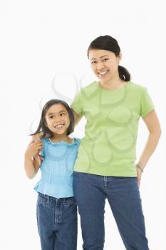 Royalty Free Photo of a Mother and Daughter Standing With Arms Around Each Other