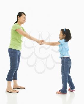 Royalty Free Photo of a Mother and Daughter Playing Together Holding Hands