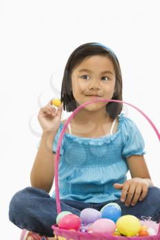 Royalty Free Photo of a Girl Sitting With an Easter Basket