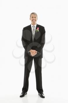 Portrait of Caucasian male in tuxedo with boutonniere.