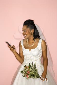 Royalty Free Photo of a Bride Holding a Cellphone 