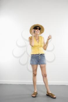 Royalty Free Photo of a Woman in Summer Attire Talking on a Cellphone