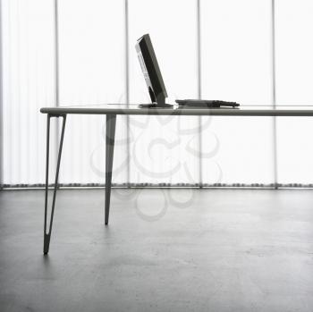 Royalty Free Photo of a Computer Monitor and Keyboard on a Modern Table