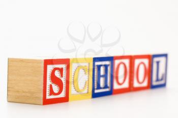 Alphabet toy building blocks spelling the word school.