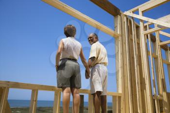 Royalty Free Photo of a Couple Holding Hands in a New Home Construction at the Beach