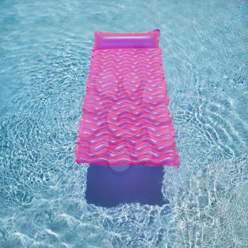Royalty Free Photo of a Pink Lounge Float in an Empty Swimming Pool