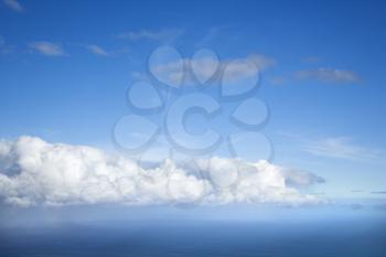 Royalty Free Photo of a Blue Sky With White Puffy Clouds