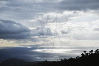 Royalty Free Photo of a View of an Island in Pacific Ocean With Clouds from Maui, Hawaii